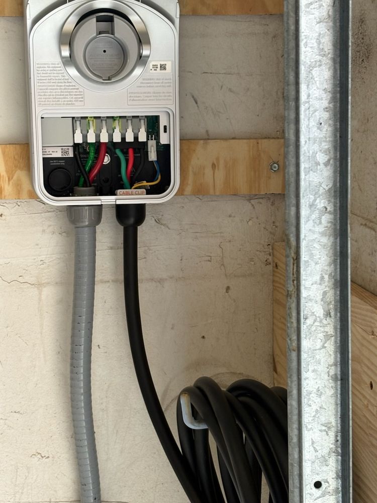 EV charger wired into its wall box with flexible conduit