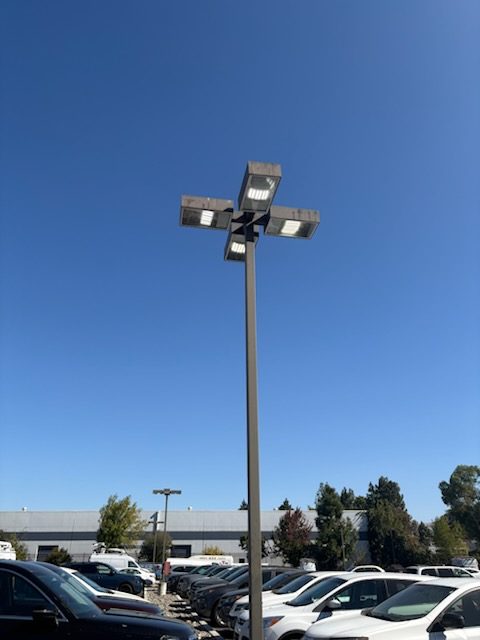 Four-head LED light pole over a parking lot
