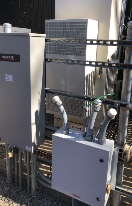 Equipment cabinets and conduit at a fenced equipment site