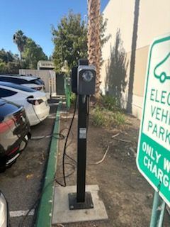 EV charging station next to an electric vehicle parking sign