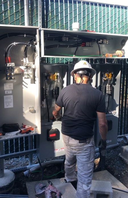 Five-O Electric electrician working inside an equipment enclosure