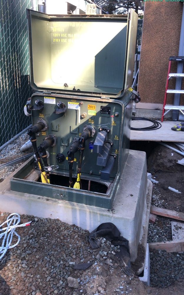 Open pad-mounted transformer on a new concrete pad